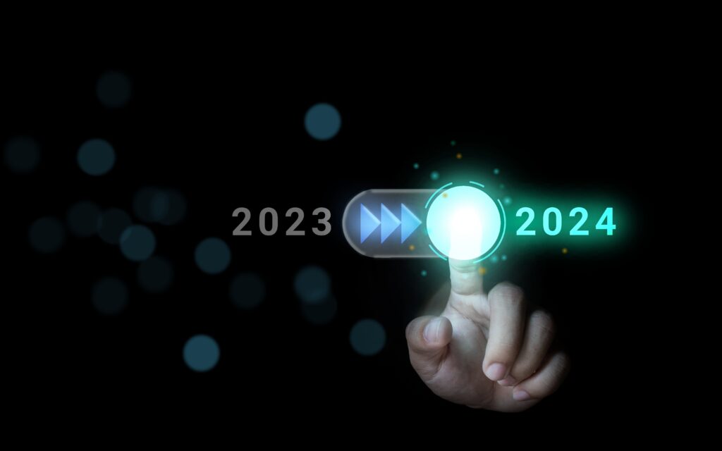 hand,turns,on,the,switch,,moving,from,2023,to,2024.