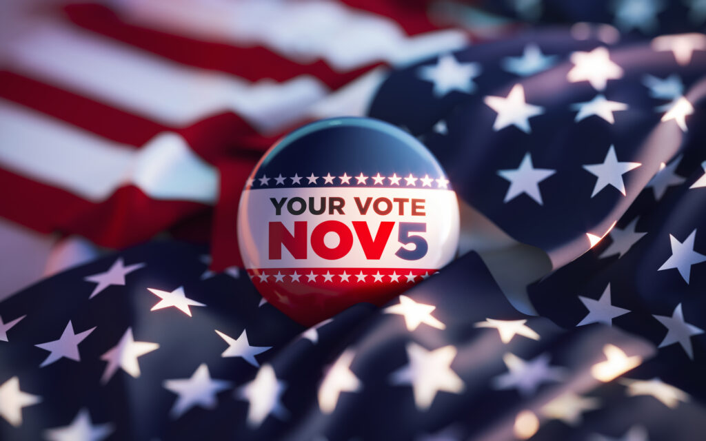 your vote november 5 printed badge on over american flag
