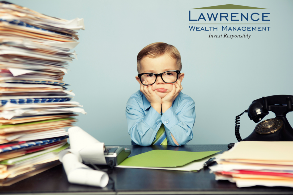 little boy wearing old timey glasses at a desk with a stack of files and an old timey telephone